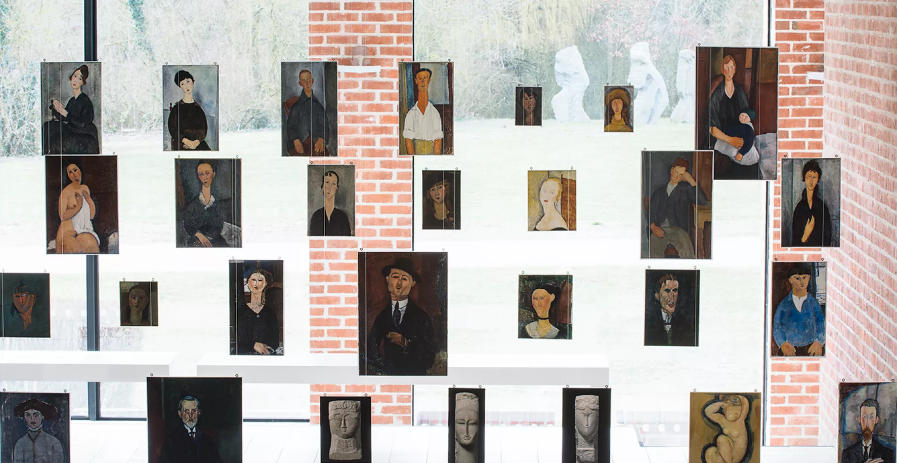 Accrochage "Les Secrets de Modigliani", des reproductions d'œuvres de la l'artistique suspendues.