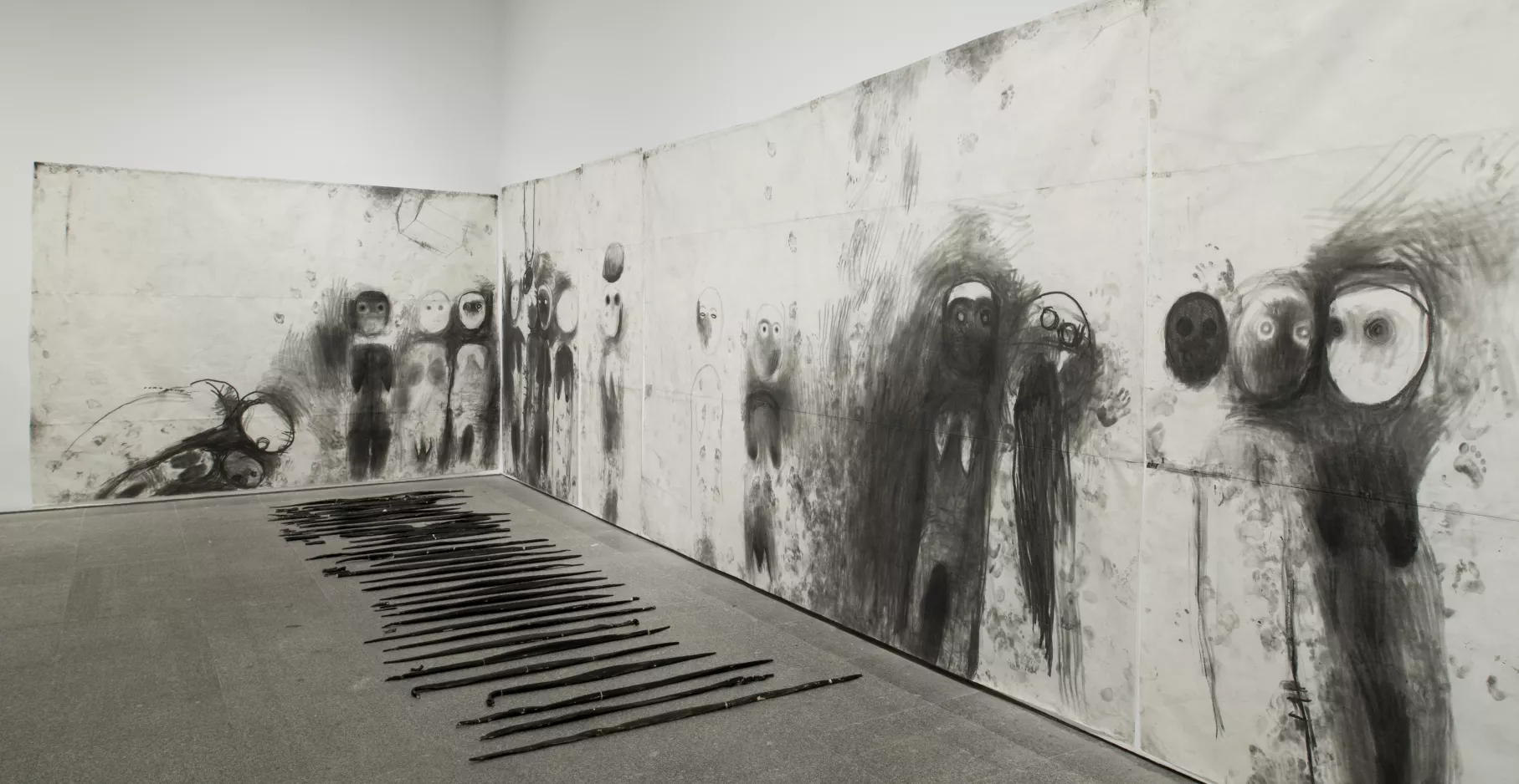 Miriam Cahn, salle d'exposition avec fresque de dessin noir sur fond blanc.