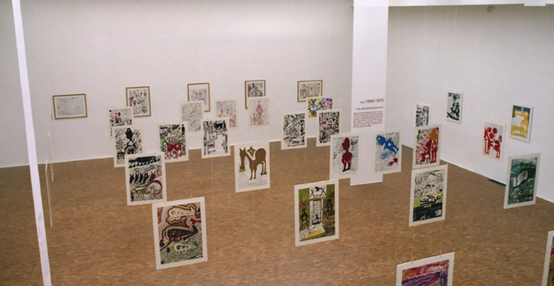 Salle d'exposition, œuvres graphiques suspendues.
